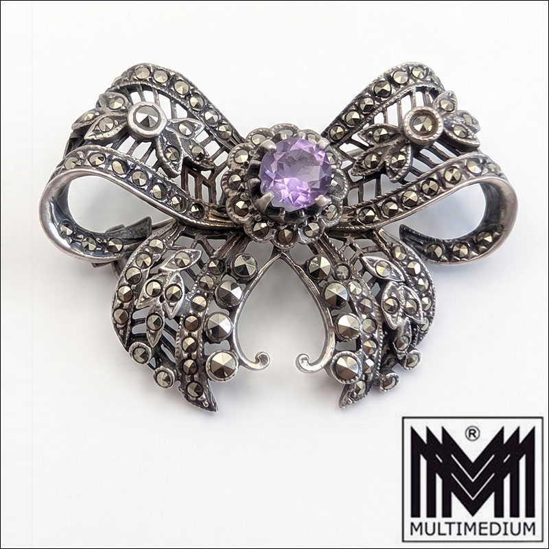 Gemini Generated Image liwo0lliwo0lliwo Art Déco Schleifenbrosche Silber 835 mit Amethyst & Markasiten um 1930